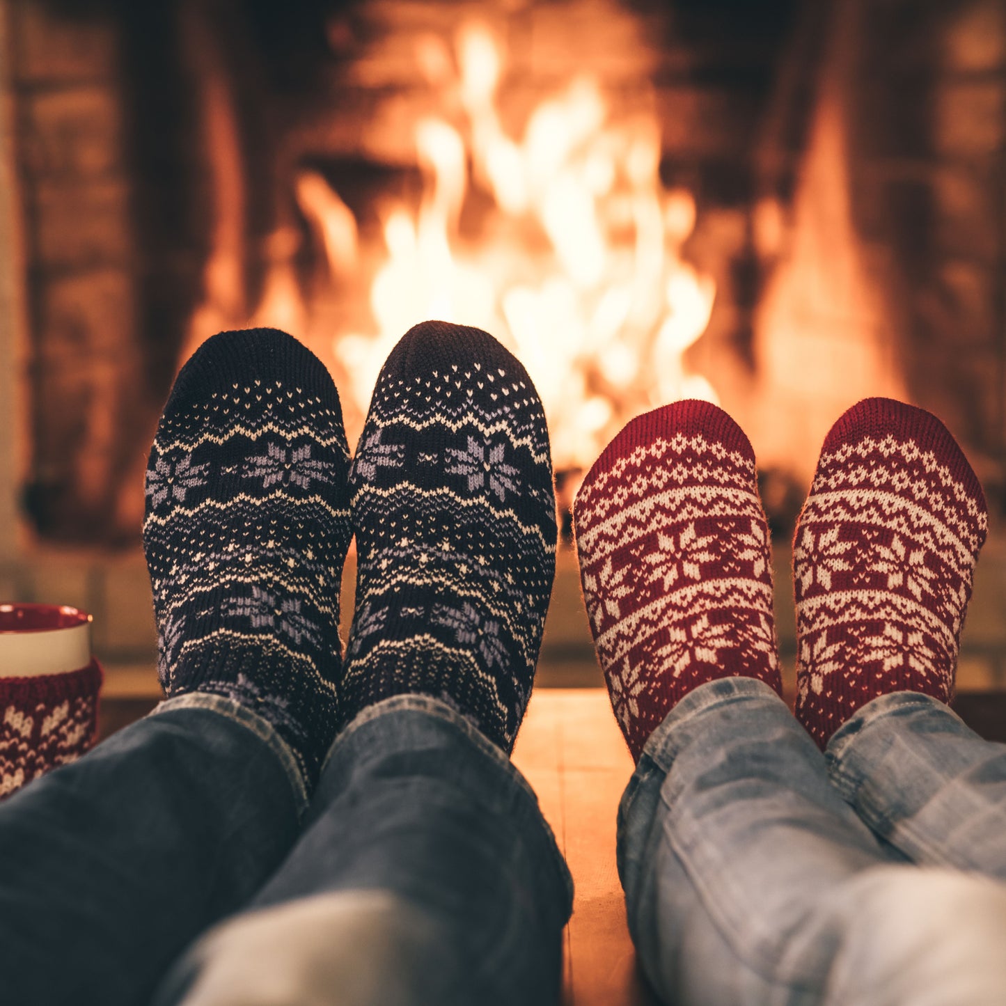 Couple wearing socks by fire