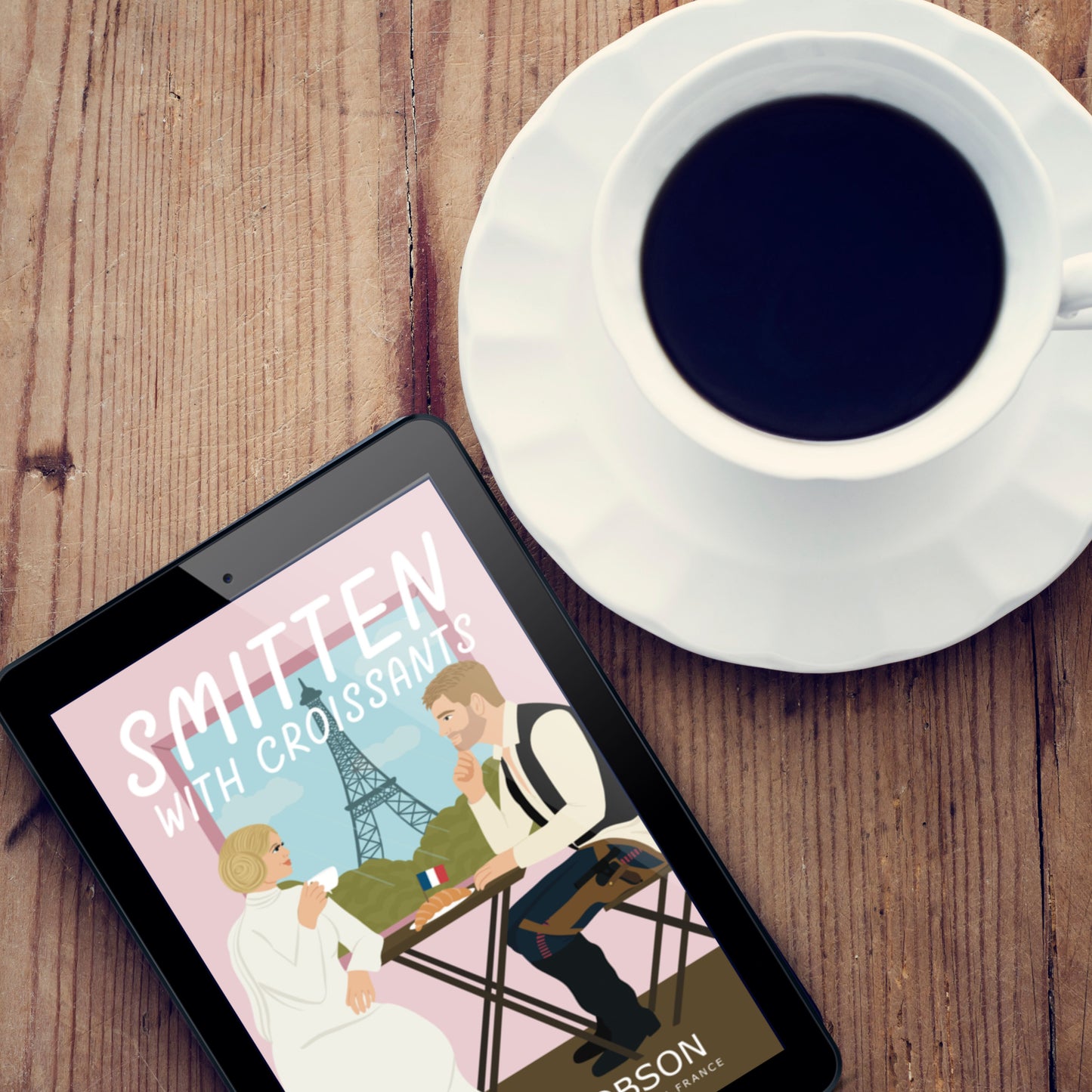 Smitten with Croissants ebook next to white coffee cup